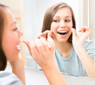 Woman flossing her teeth