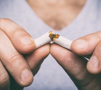 Person breaking a cigarette