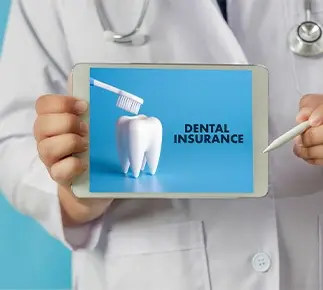 Dentist pointing to tablet that says Dental Insurance