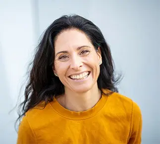 Woman in orange shirt smiling