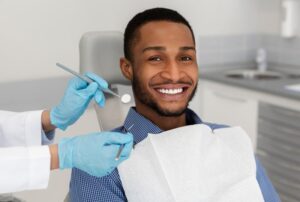 Man smiling after getting his dental crown placed
