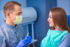 female patient talking to dentist about veneers